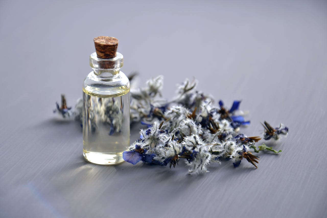 Services-01 Close-up of a lavender oil bottle with dried flowers for aromatherapy. Perfect for wellness themes.